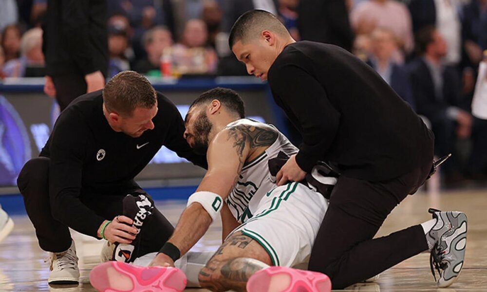 Jayson Tatum in Celtics uniform during a game, illustrating his recovery from an Achilles injury.