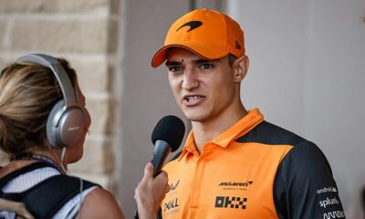 Alex Palou in racing suit with McLaren F1 car, facing $20 million lawsuit from the team.