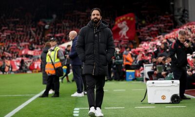 Manchester United player executing a long ball against Liverpool's high defensive line in the Premier League.