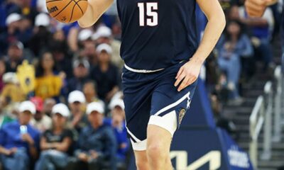 Nikola Jokić dribbling the basketball during an NBA game for his back-to-back triple-double performance.