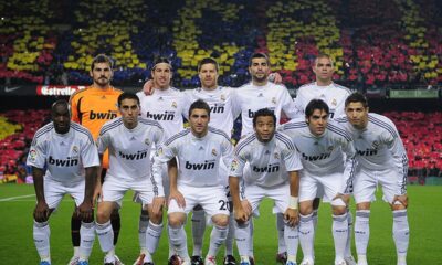 Xabi Alonso celebrating with Real Madrid teammates during his first El Clásico match against Barcelona.