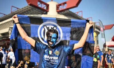 Exterior view of an historic Italian football stadium built during the fascist era, with concrete architecture.