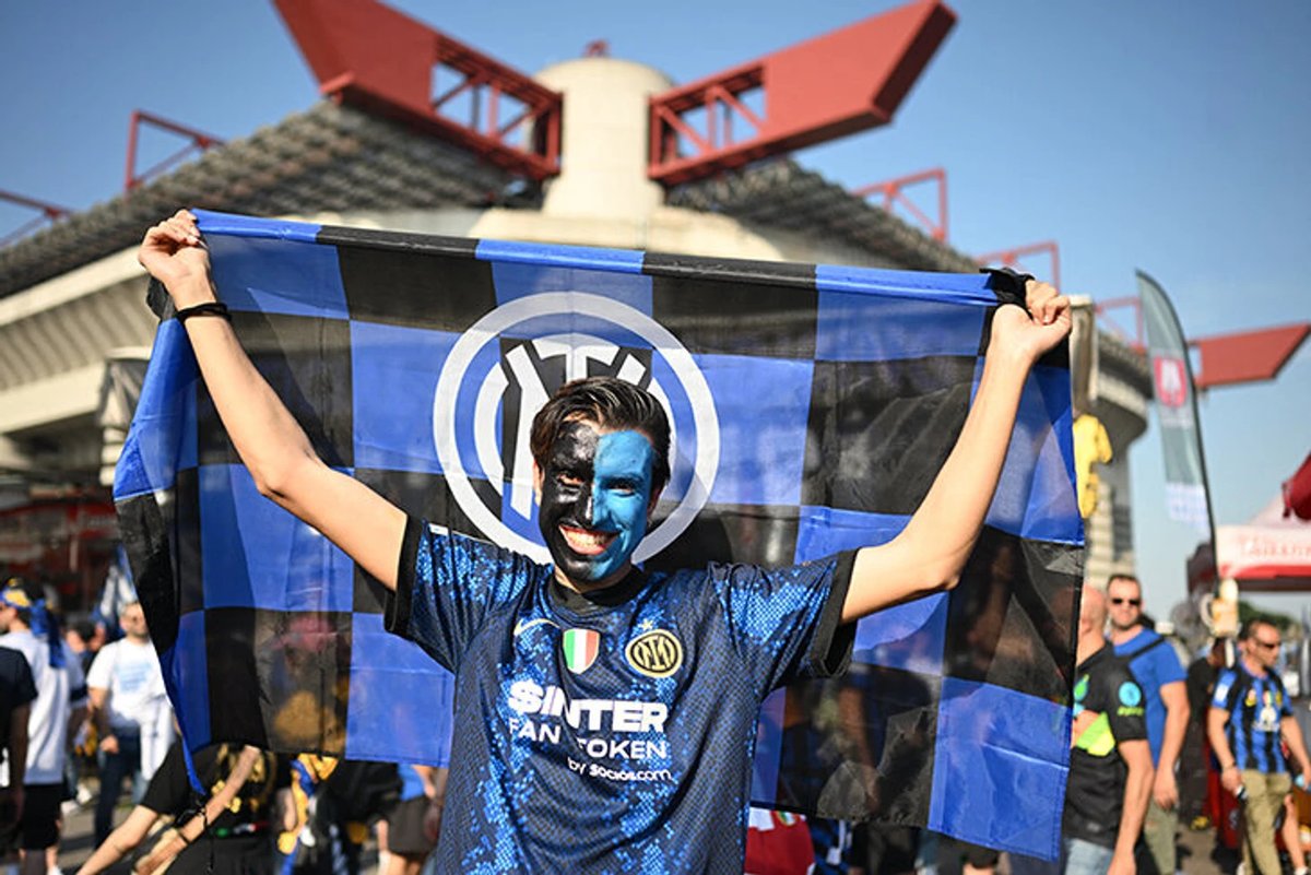 Exterior view of an historic Italian football stadium built during the fascist era, with concrete architecture.