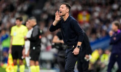 Real Madrid players celebrating a goal against Barcelona in El Clásico at the Bernabéu.