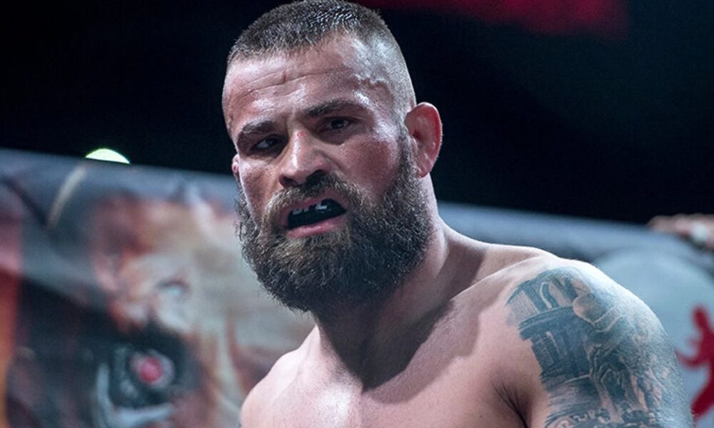 Ex-UFC fighter poses in his home zoo with large crocodiles and sharks in a Mike Tyson-inspired private collection.