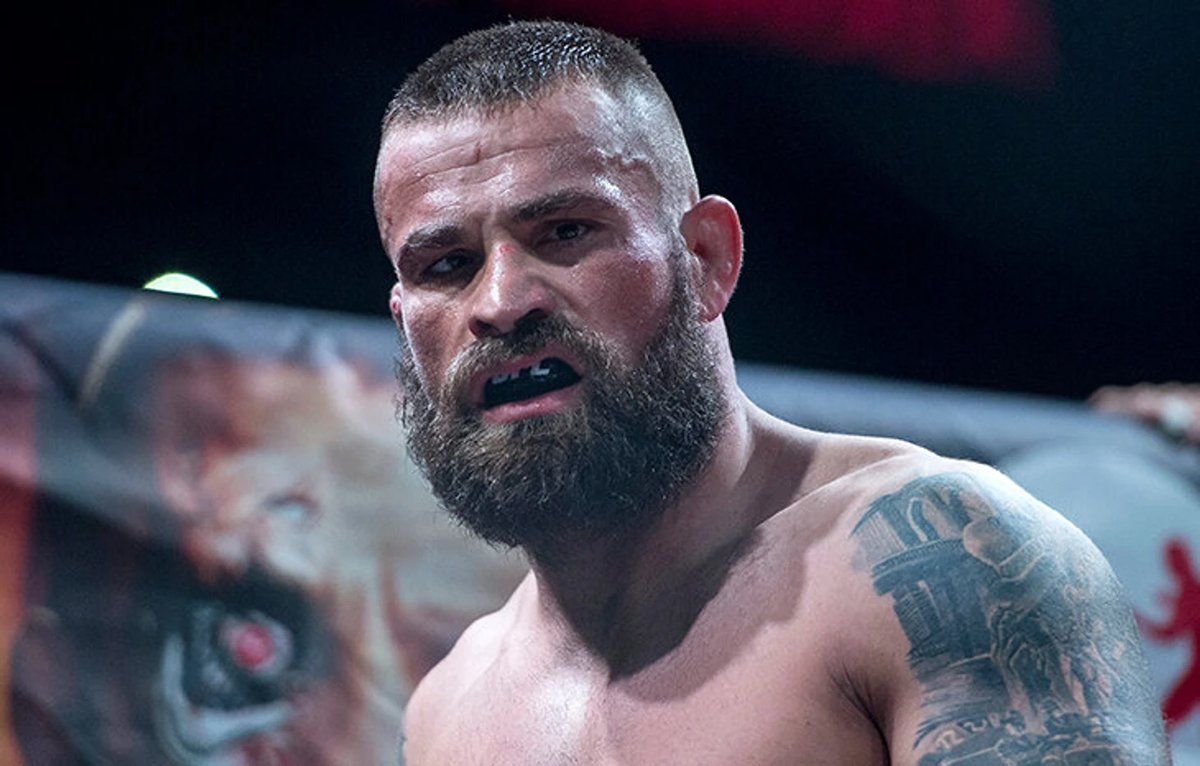 Ex-UFC fighter poses in his home zoo with large crocodiles and sharks in a Mike Tyson-inspired private collection.