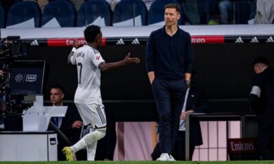 Vinicius Junior arguing with referee during a match, showing frustration over a decision.