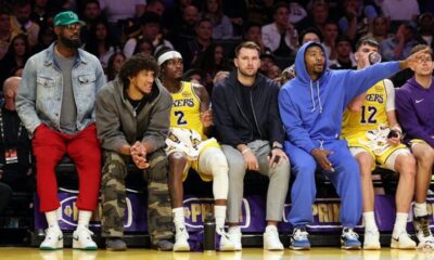 Lakers players celebrating a basket during a game without LeBron James and Luka Doncic on the court.