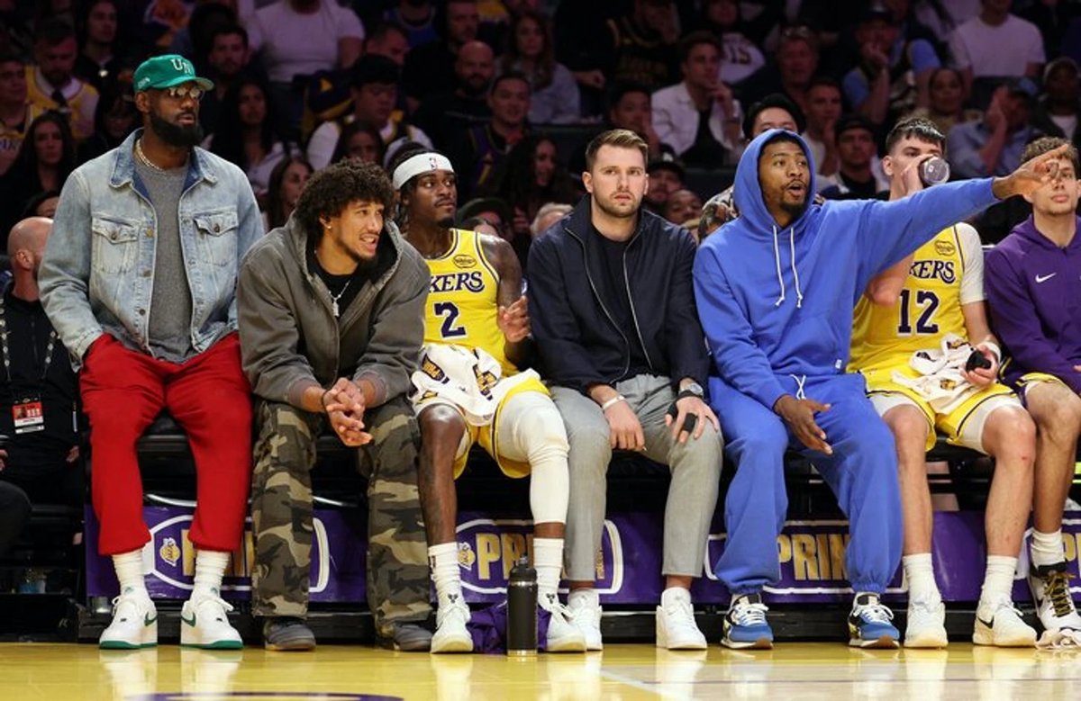 Lakers players celebrating a basket during a game without LeBron James and Luka Doncic on the court.