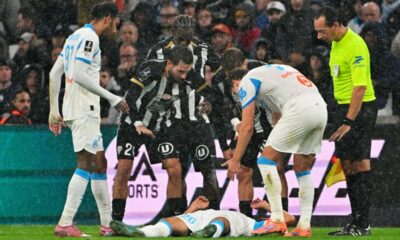Marseille soccer player receiving medical attention on the pitch after collapsing during a match.