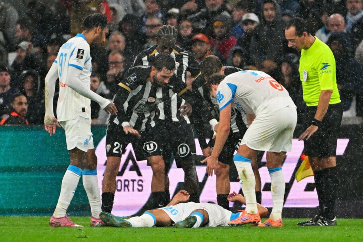 Marseille soccer player receiving medical attention on the pitch after collapsing during a match.