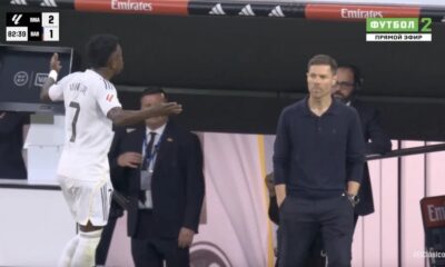 Vinicius Junior reacts angrily after being substituted in El Clasico, showing frustration on the Real Madrid bench.