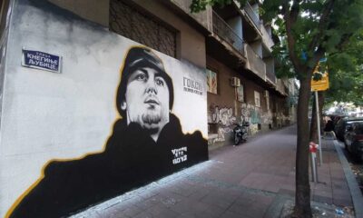 Serbian football ultras in team colors at a stadium, representing the fan-to-criminal power shift