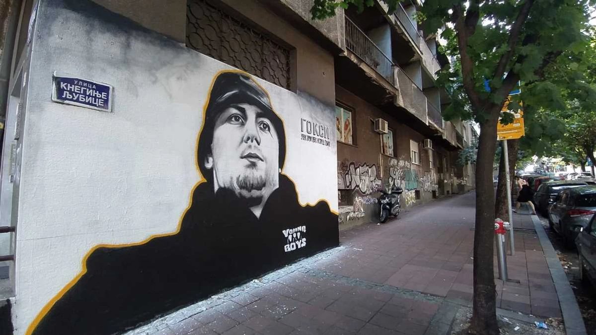 Serbian football ultras in team colors at a stadium, representing the fan-to-criminal power shift