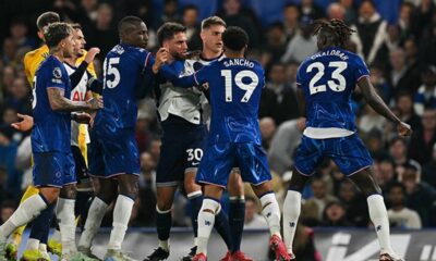 Chelsea vs Tottenham players clashing in a fierce London derby match at Stamford Bridge stadium.