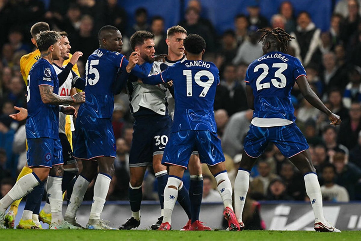 Chelsea vs Tottenham players clashing in a fierce London derby match at Stamford Bridge stadium.