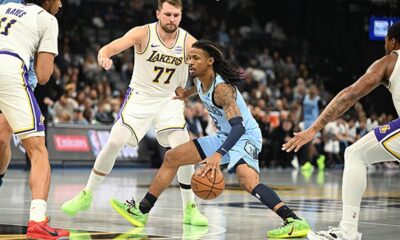 Memphis Grizzlies star Ja Morant in his team jersey looking serious during a game.
