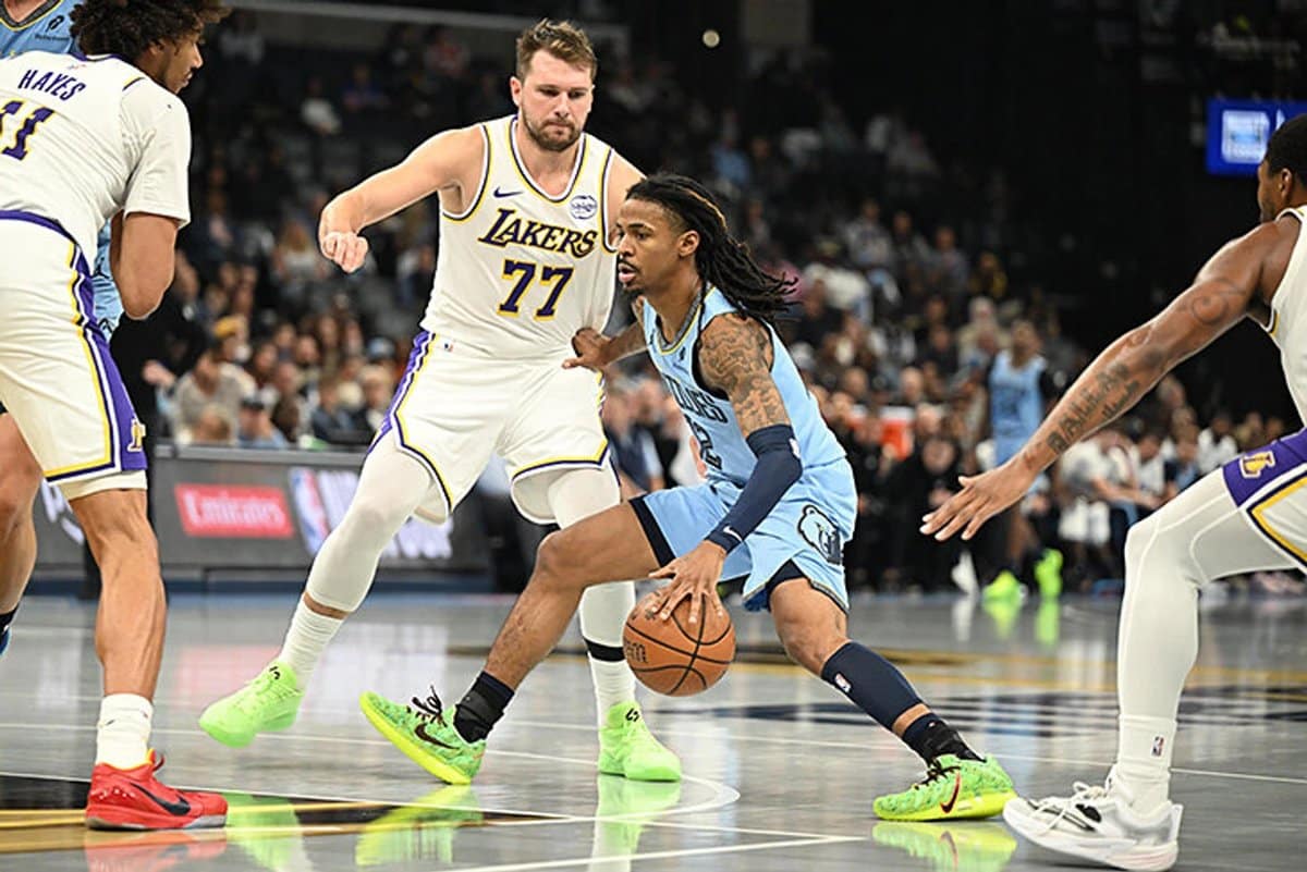 Memphis Grizzlies star Ja Morant in his team jersey looking serious during a game.