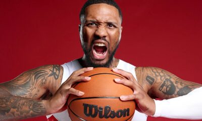 Doc Rivers on the Milwaukee Bucks sideline coaching Giannis Antetokounmpo and Damian Lillard during a game.