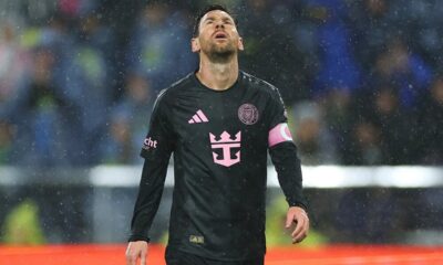 Lionel Messi of Inter Miami dribbles past a defender in an MLS match, looking focused.