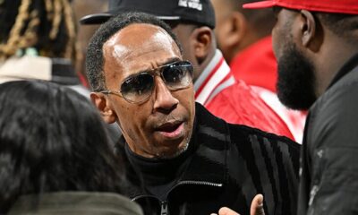 Skip Bayless on TV set passionately debating LeBron James with a critical expression.