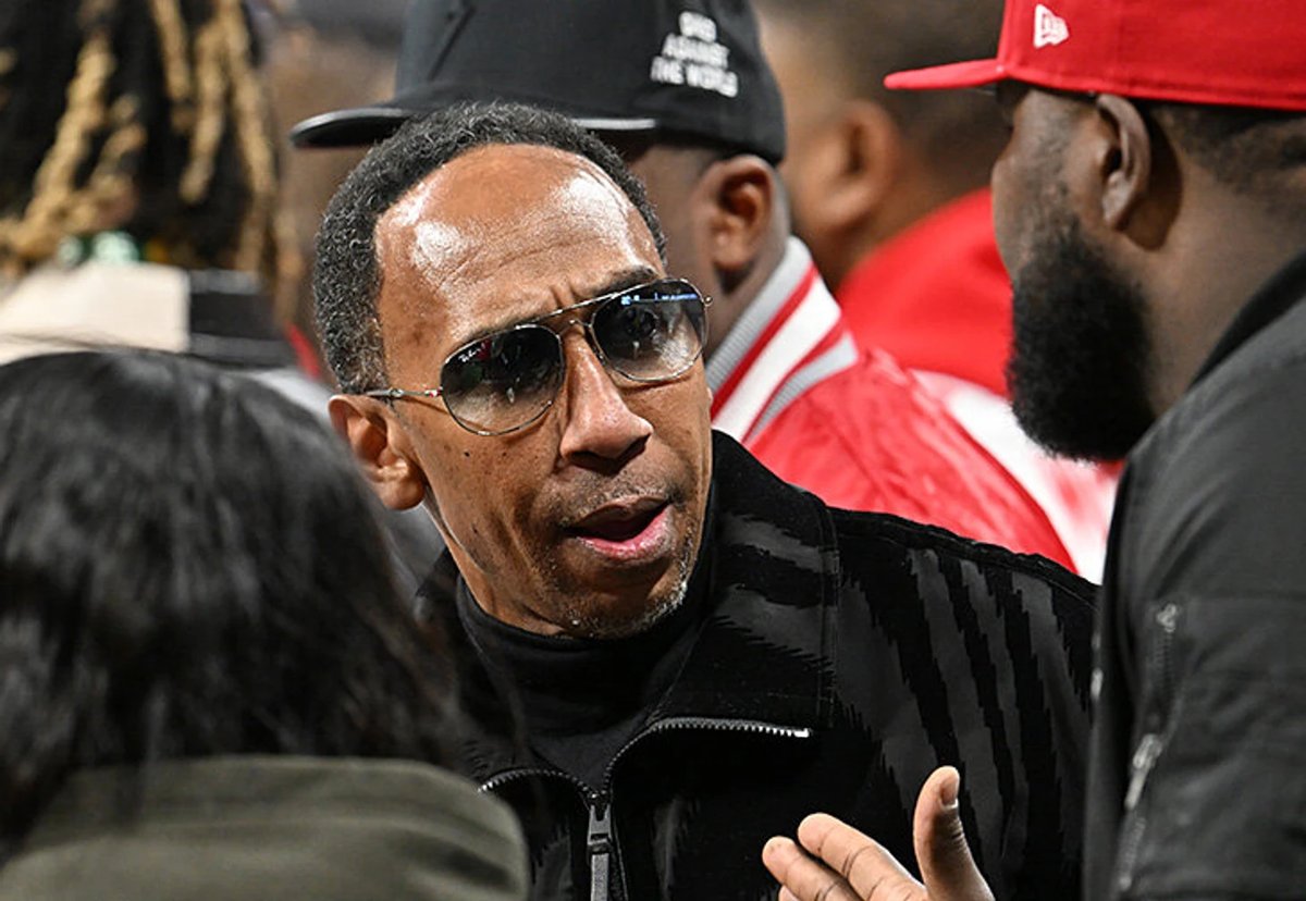 Skip Bayless on TV set passionately debating LeBron James with a critical expression.